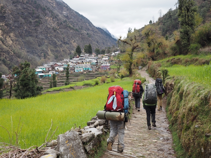 4 gap year students backpacking on a trail