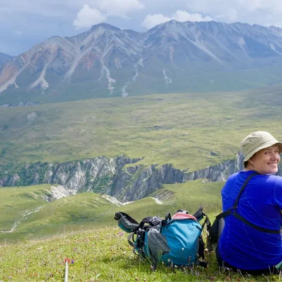 A student takes a moment to rest and enjoy the view in the Talkeetna Mountains.