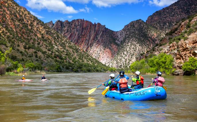 david-morgan-rm-37.jpg__685x423_q70_crop_subject_location-3674,1902_subsampling-2 Course participants paddle in a raft and on kayaks on the river