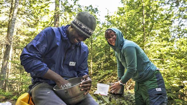 kirk_rasmussen_ne-133-edit.jpg__655x5000_q70_subject_location-960,539_subsampling-2 A student and an instructor laugh together while making dough for cinnamon rolls.