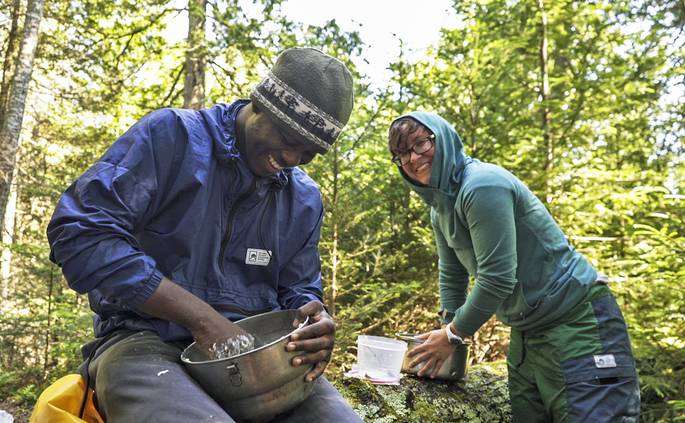 kirk_rasmussen_ne-133-edit.jpg__685x423_q70_crop_subject_location-960,539_subsampling-2 A student and an instructor laugh together while making dough for cinnamon rolls.