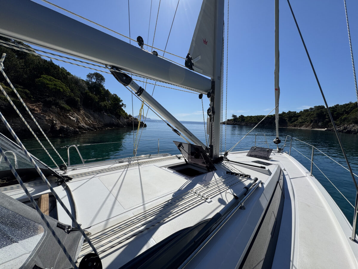 Mast and rigging of sail boat against stunning blue skies of Greece, and blue waters of Ionian Sea.