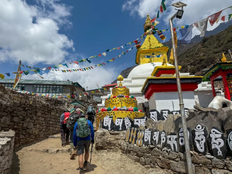 Prayer flags and a temple next to the trail