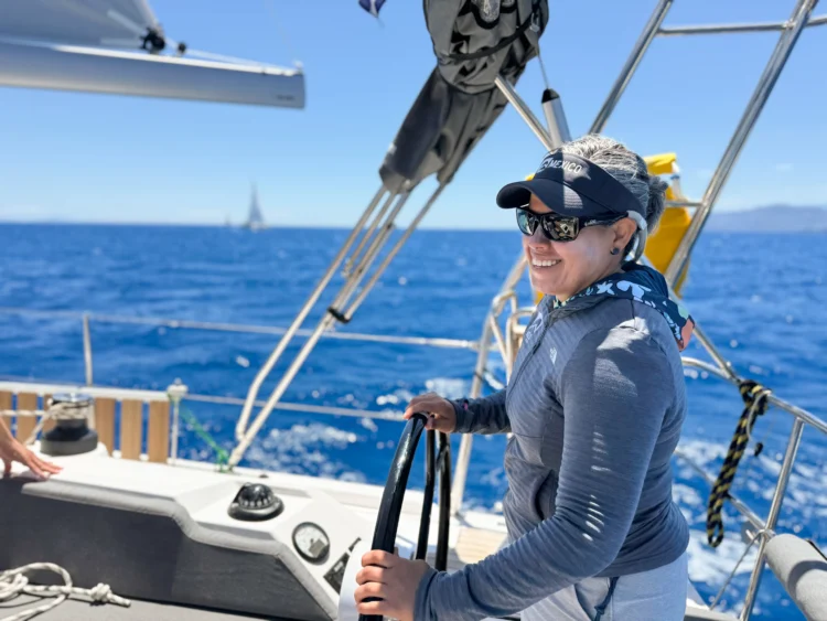 Sailor steers the boat