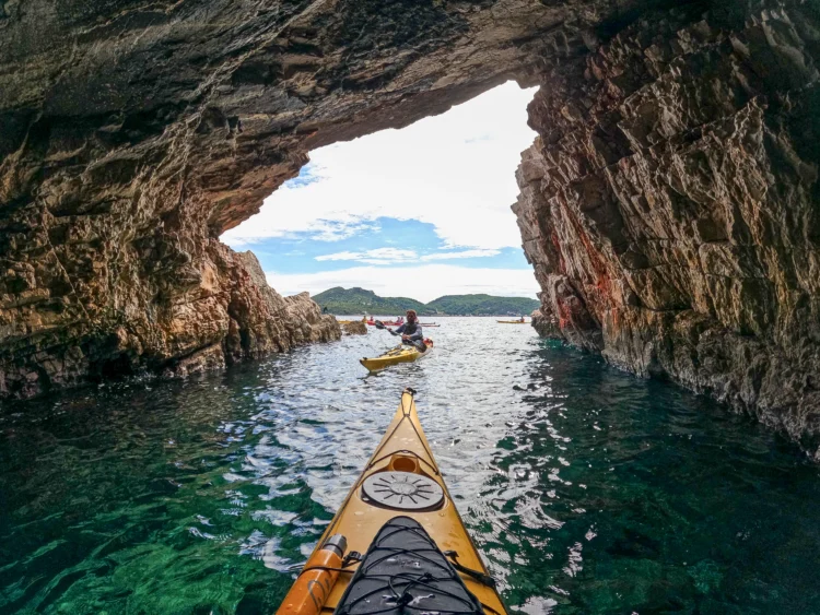 A kayak goes through a limestone cave in Croatia