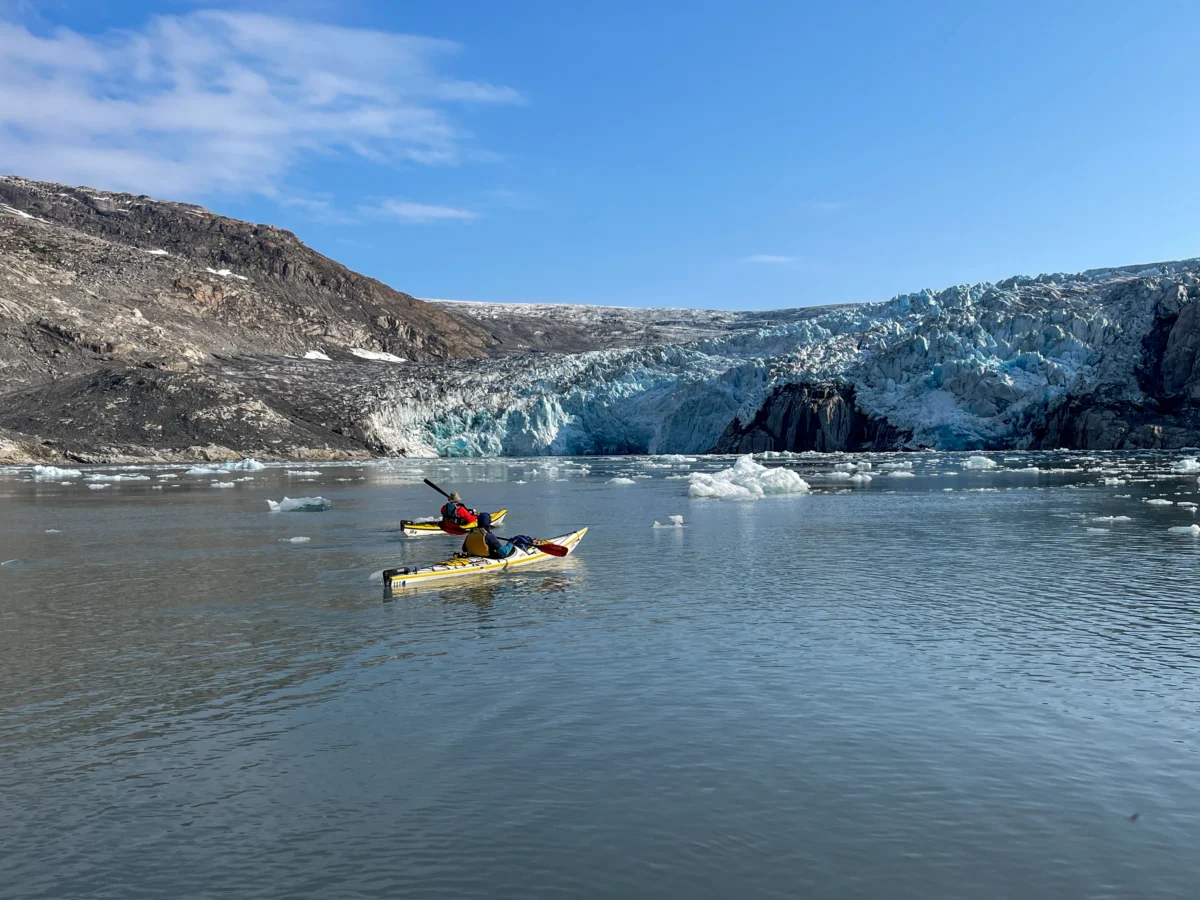 Kayakers paddle towards a glacier in Prince William Sound