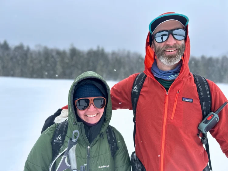 Skiers smile in the snow in Maine