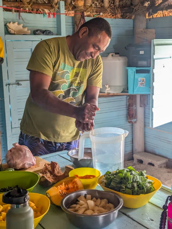 Man squeezes juice from fruit in Fiji