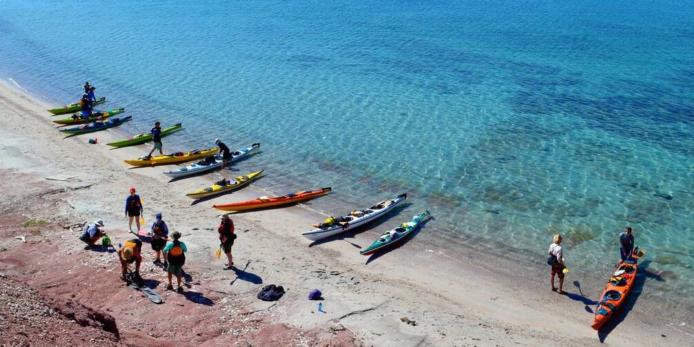 kate-gautier-mx-002.jpg__1400x503_q70_crop_subject_location-1665,2011_subsampling-2_upscale Students loading up their sea kayaks on shore next to the stunning aqua waters of the Sea of Cortez in Baja California, Mexico.